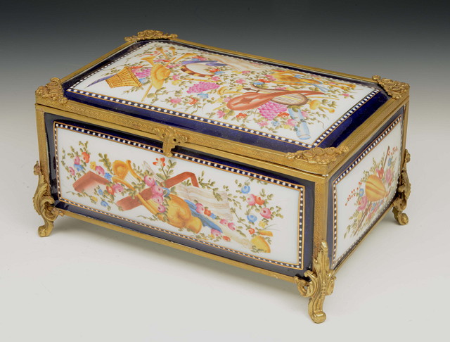 Appraisal: A HAND PAINTED PORCELAIN AND GILT METAL MOUNTED CASKET the