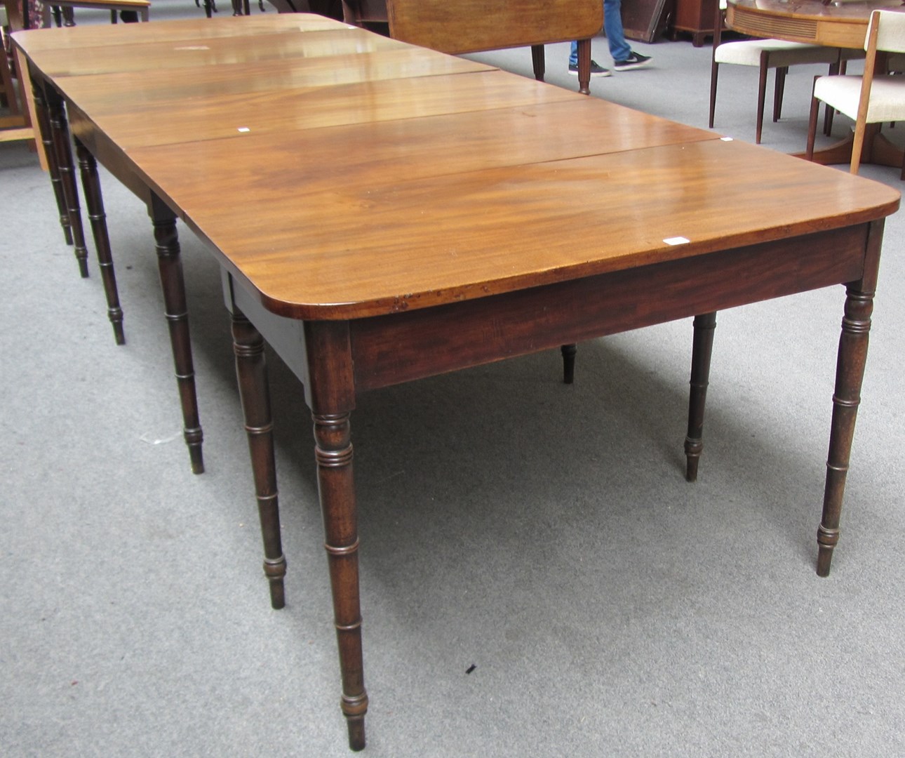 Appraisal: An early th century mahogany triple section extending dining table