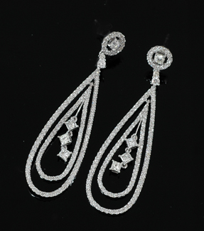 Appraisal: A pair of diamond drop earrings Each having a central