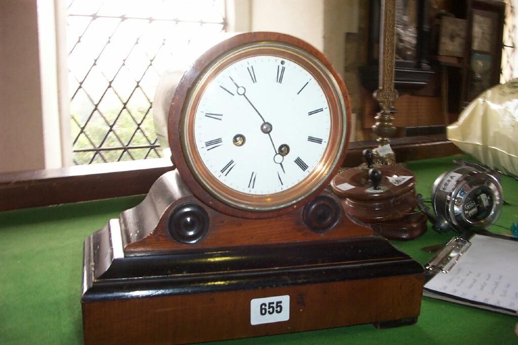 Appraisal: A Victorian mantle clock with a walnut and ebonised case