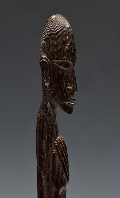 Appraisal: AN AFRICAN CARVED HARDWOOD ELONGATED FIGURE of a man with