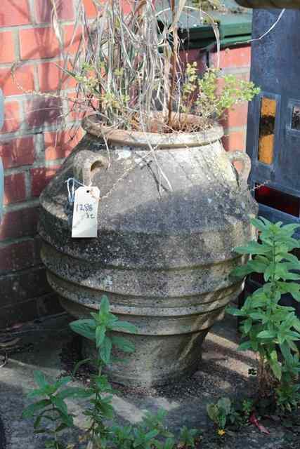 Appraisal: A PAIR OF TERRACOTTA OVOID PLANTERS with three lug handles