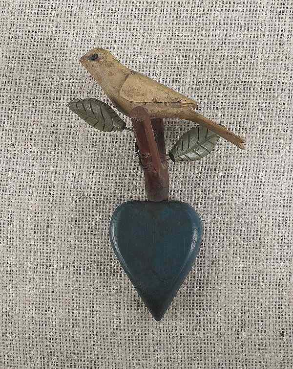 Appraisal: Carved and polychrome painted song bird on a heart form