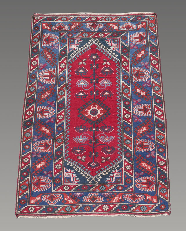 Appraisal: APPROX - YR OLD TURKISH VILLAGE HAND KNOTTED WOOL RUG