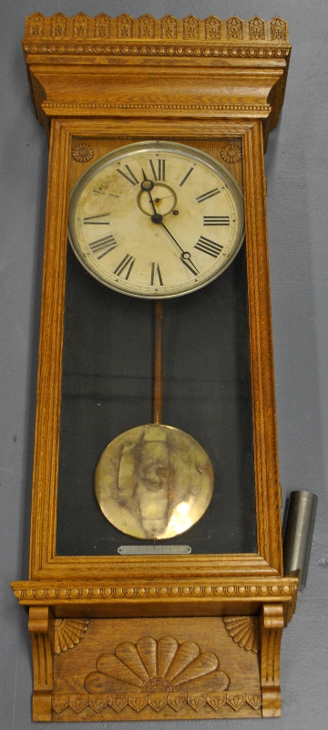 Appraisal: - Wm Gilbert oak cased wall clock with a carved