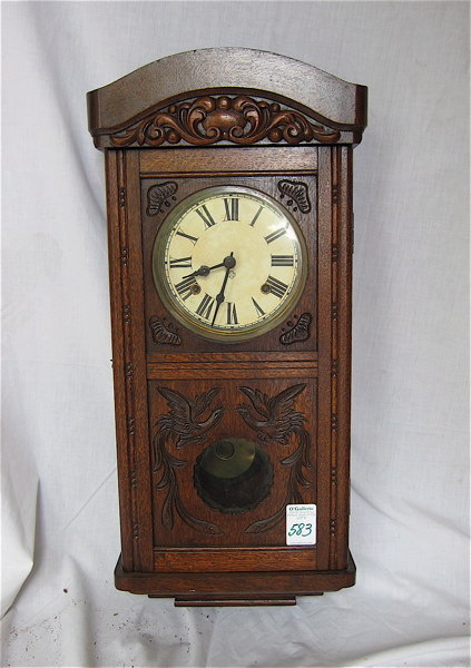 Appraisal: CARVED OAK BOX-CASE WALL CLOCK Ansonia Clock Co American early