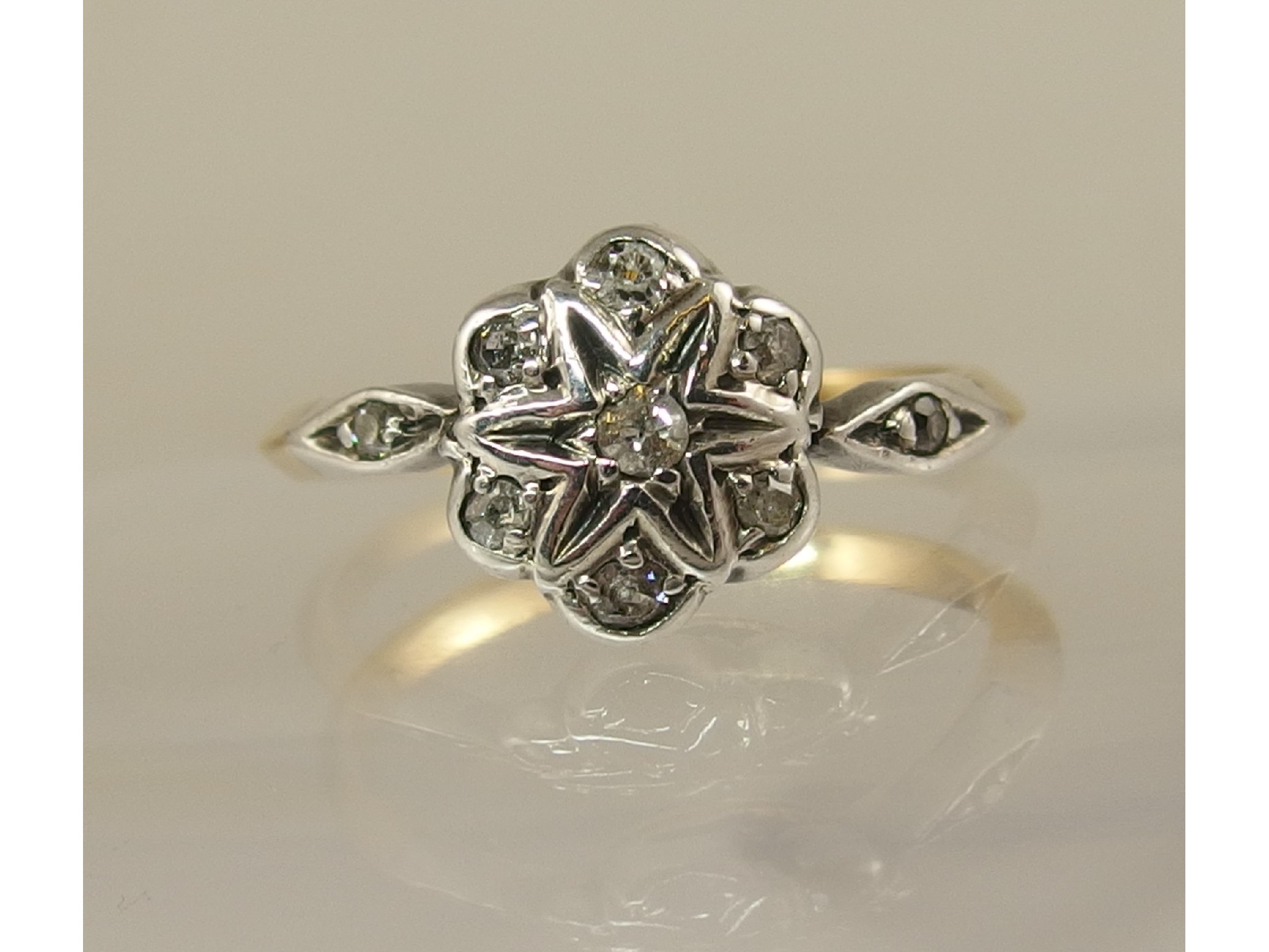 Appraisal: A yellow and white metal diamond flower ring