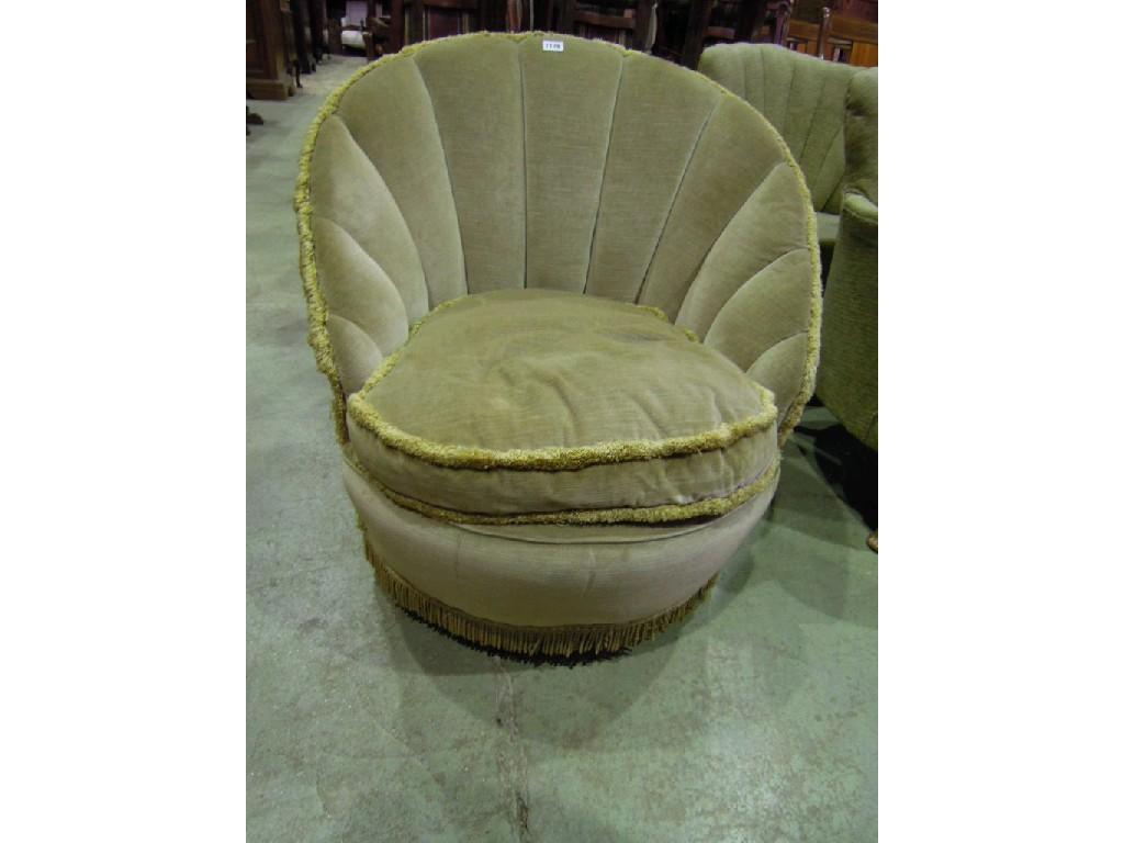 Appraisal: An upholstered tub chair with shell shaped back and tassled