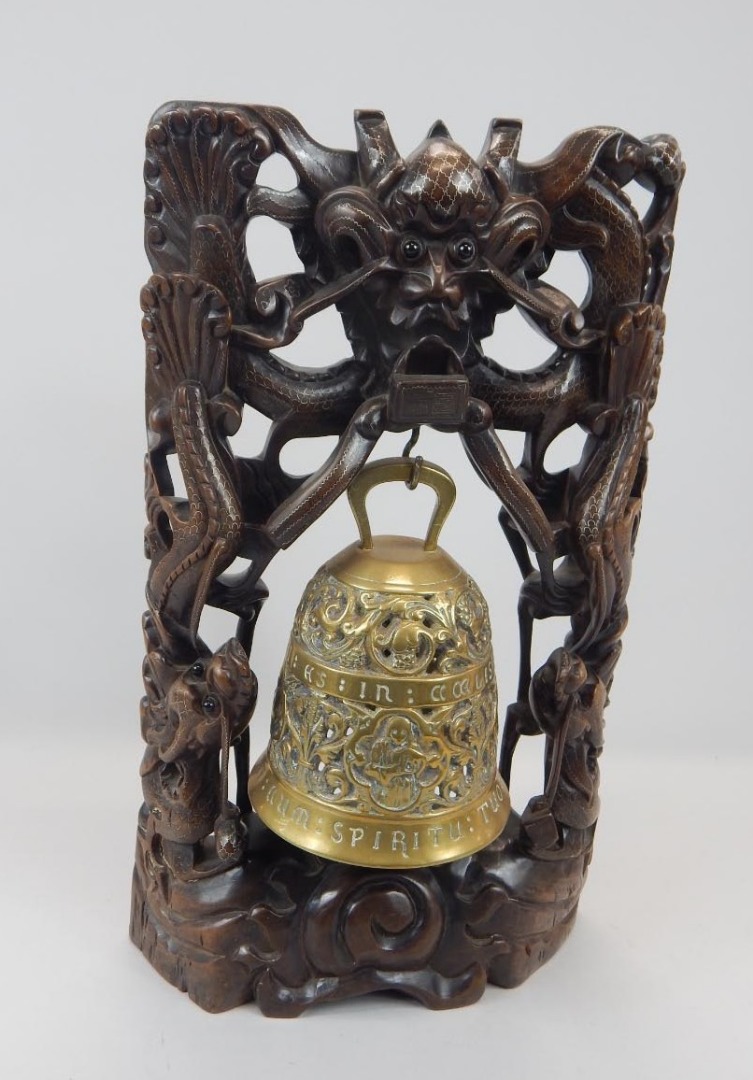 Appraisal: An oriental hardwood and white metal temple type bell stand