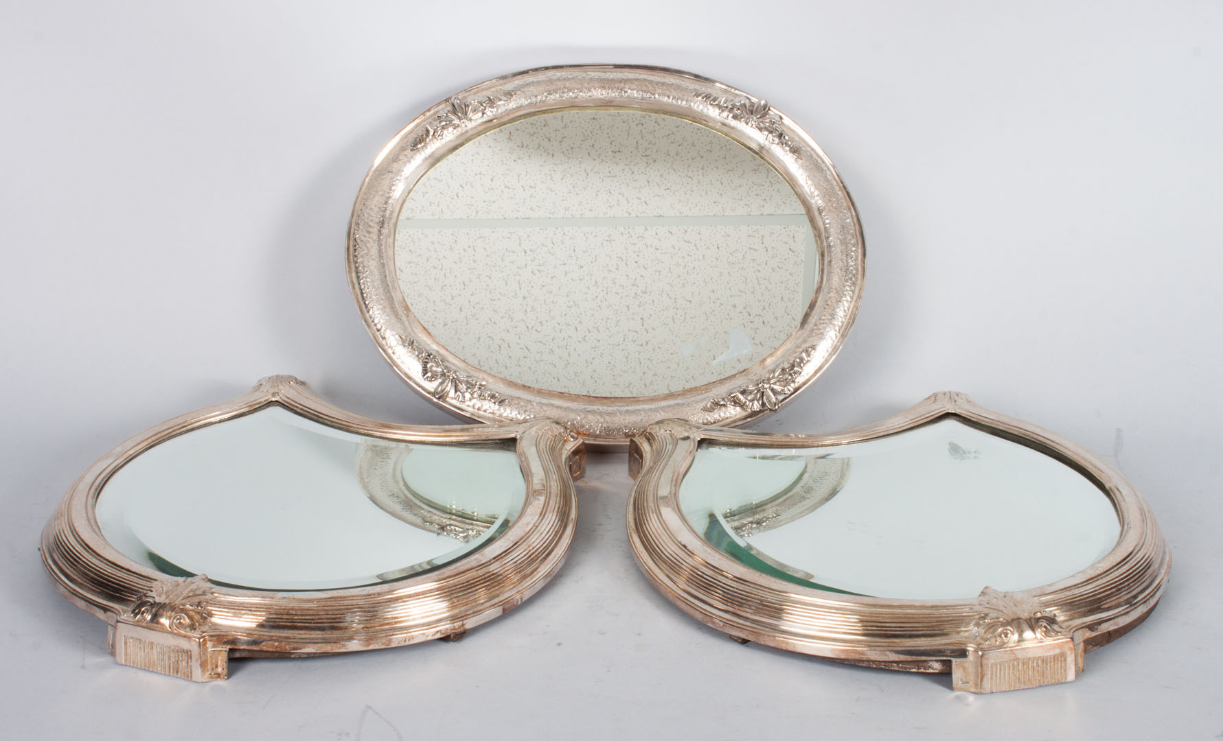 Appraisal: Three silver-plated mirrored plateaus Pair of shield shaped plateaus -