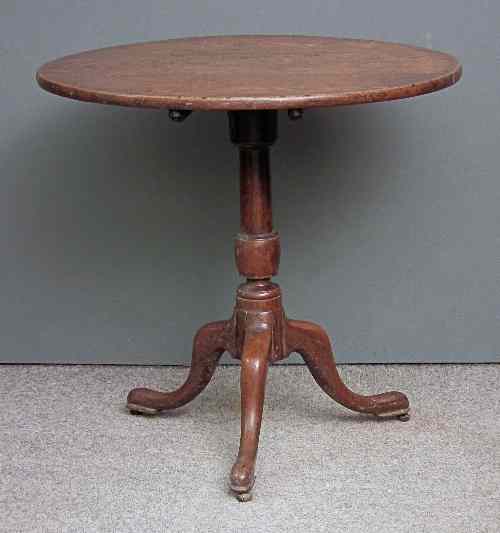 Appraisal: A George III oak circular tripod table with three plank