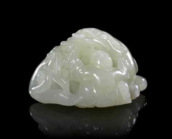 Appraisal: A Carved Jade Toggle of pale celadon colored stone depicting