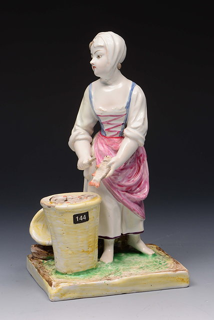 Appraisal: AN TH CENTURY NIDERVILLER FAIENCE FIGURE of a fisherwoman gutting