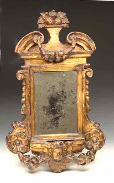 Appraisal: AN ANTIQUE ITALIAN WALL MIRROR with cherubs head and swag