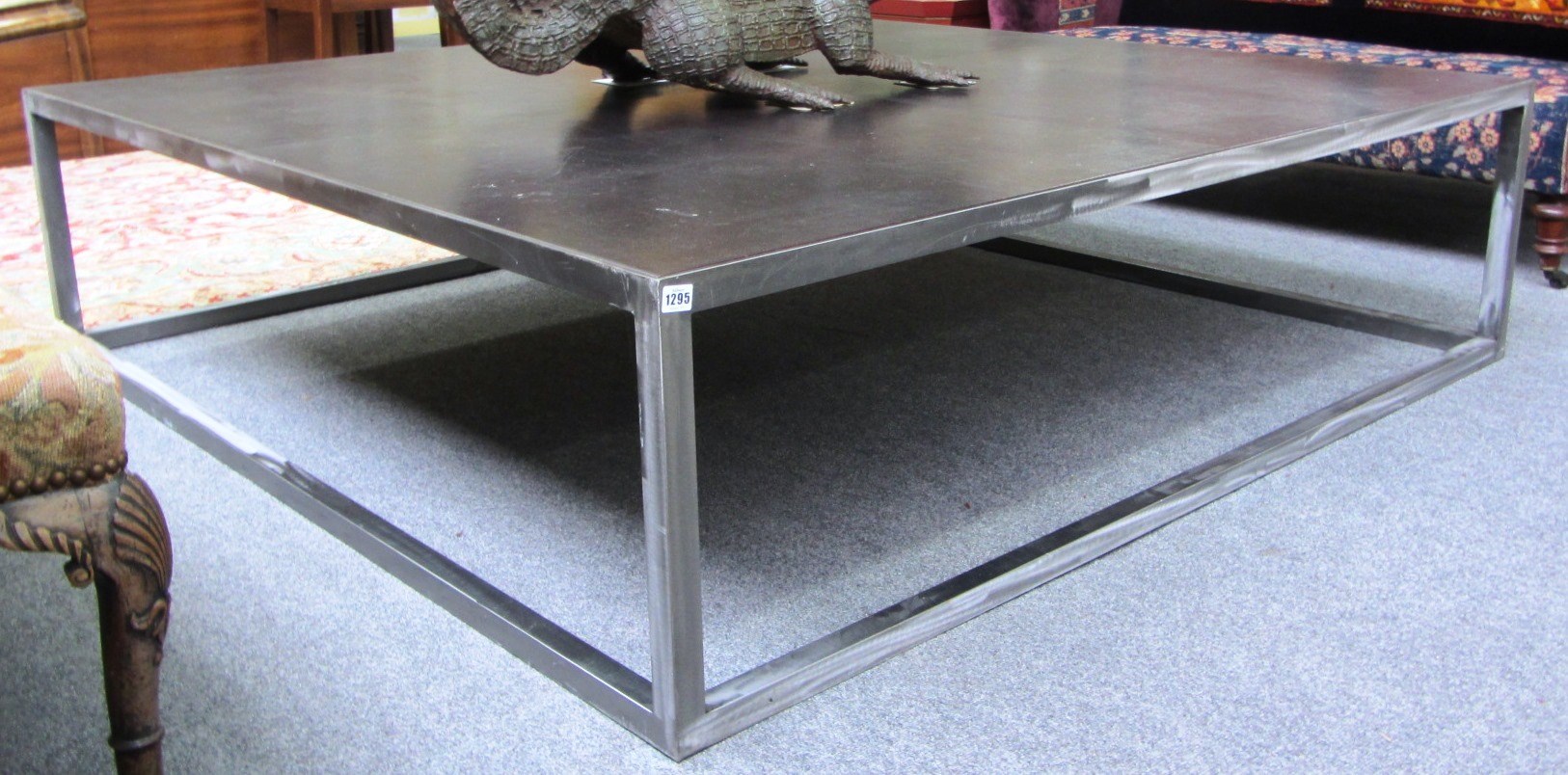 Appraisal: A large th century square steel and leather coffee table