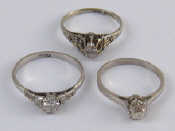 Appraisal: A mixed lot comprising three white metal diamond rings one