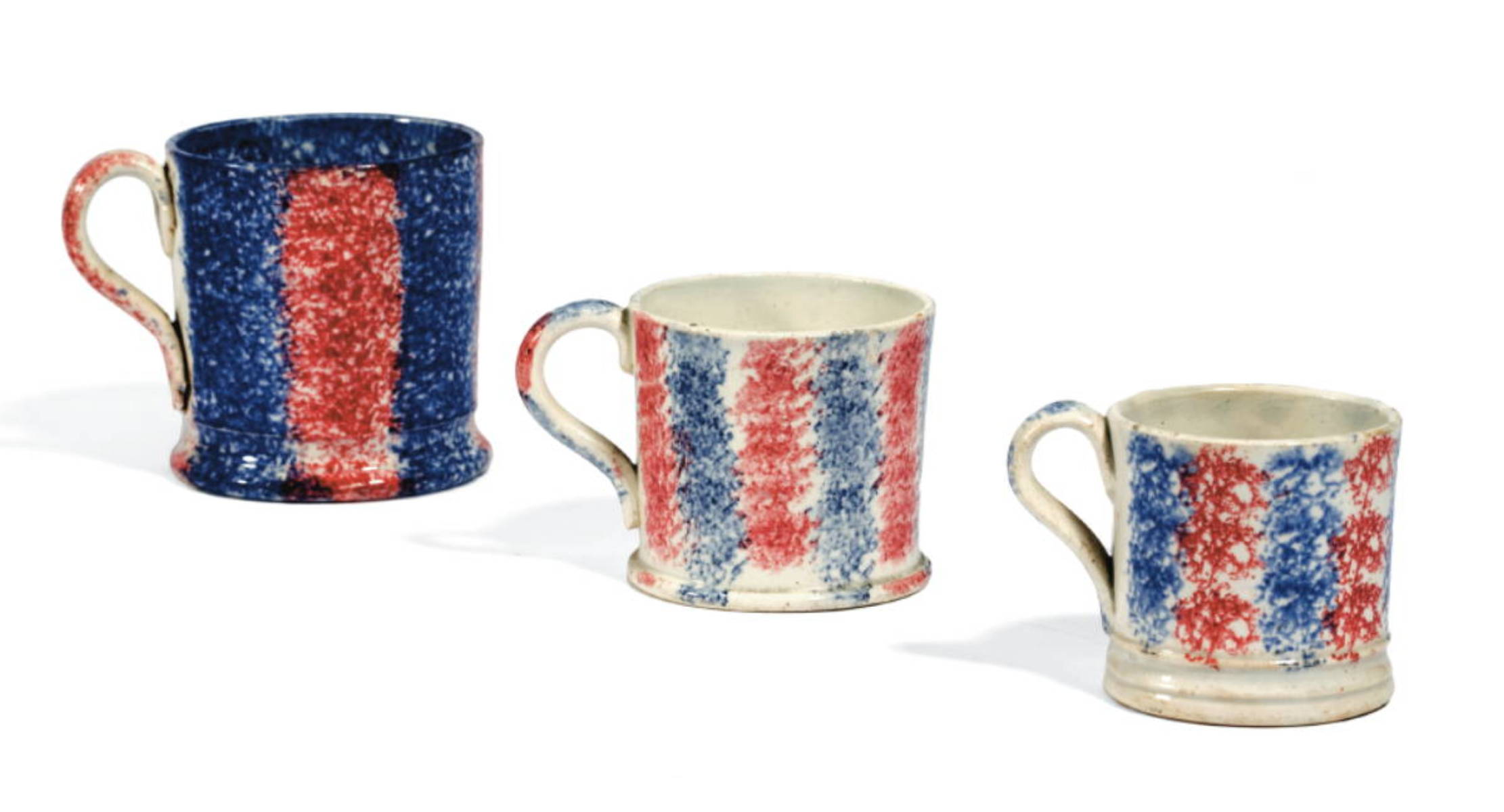 Appraisal: THREE STAFFORDSHIRE BLUE AND RED SPATTERWARE CHILDREN quot S MUGS