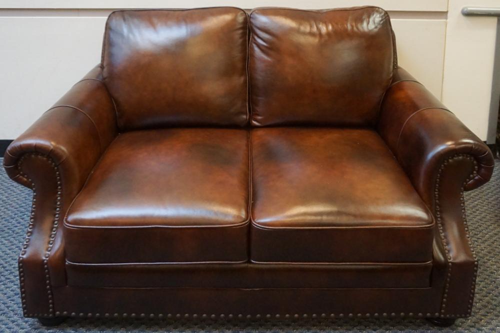 Appraisal: ABBYSON LIVING BROWN LEATHER AND NAIL STUDDED TWO CUSHION LOVESEAT