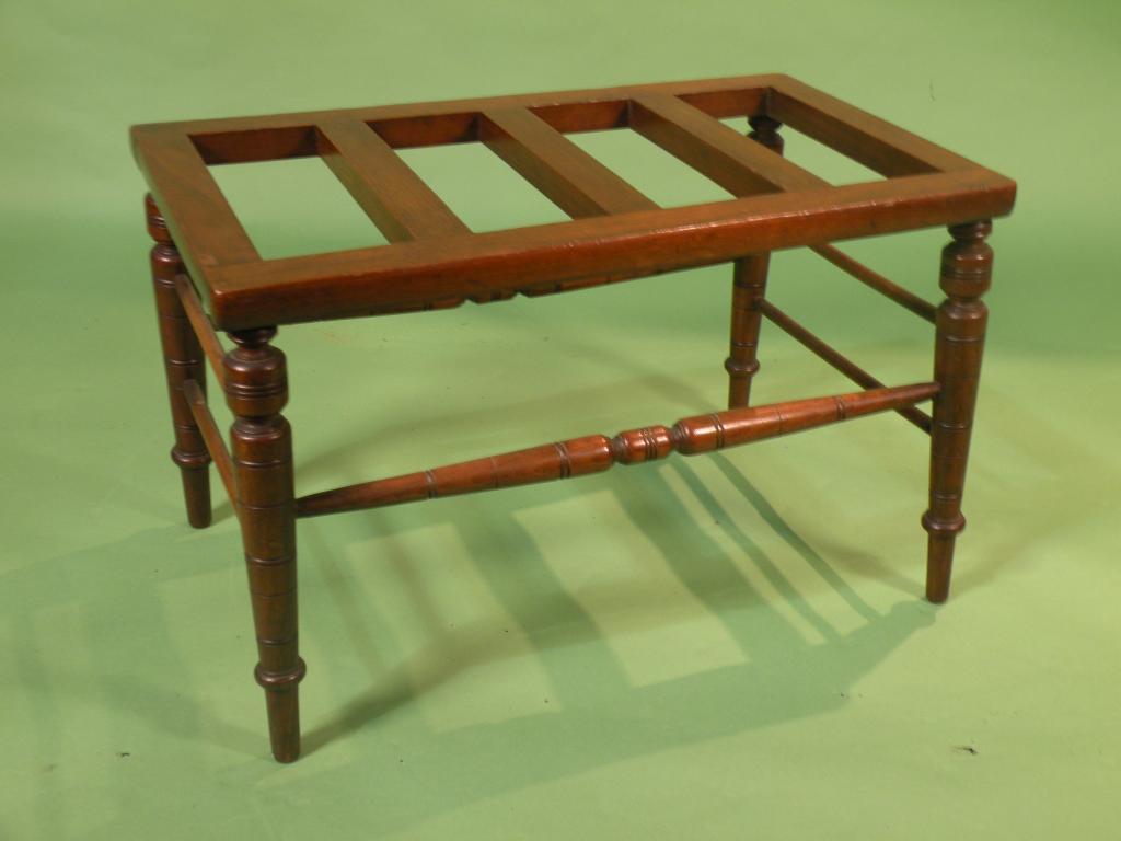 Appraisal: A Victorian walnut luggage stand with turned stretcher and legs