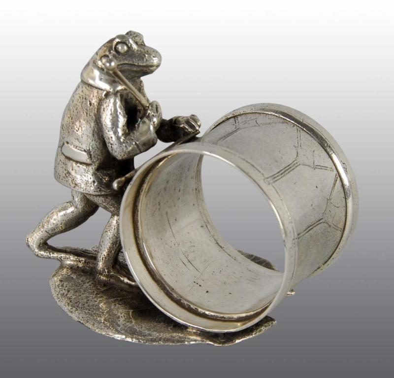 Appraisal: Suited Frog with Drum Sticks Figural Napkin Ring Description Reed