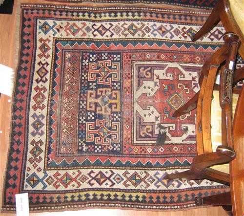 Appraisal: KAZAK antique Central field with three square medallions geometrically patterned