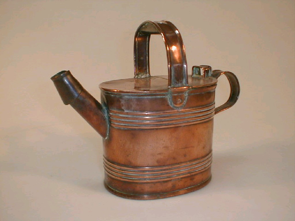 Appraisal: A copper water can with a fixed overhead handle and