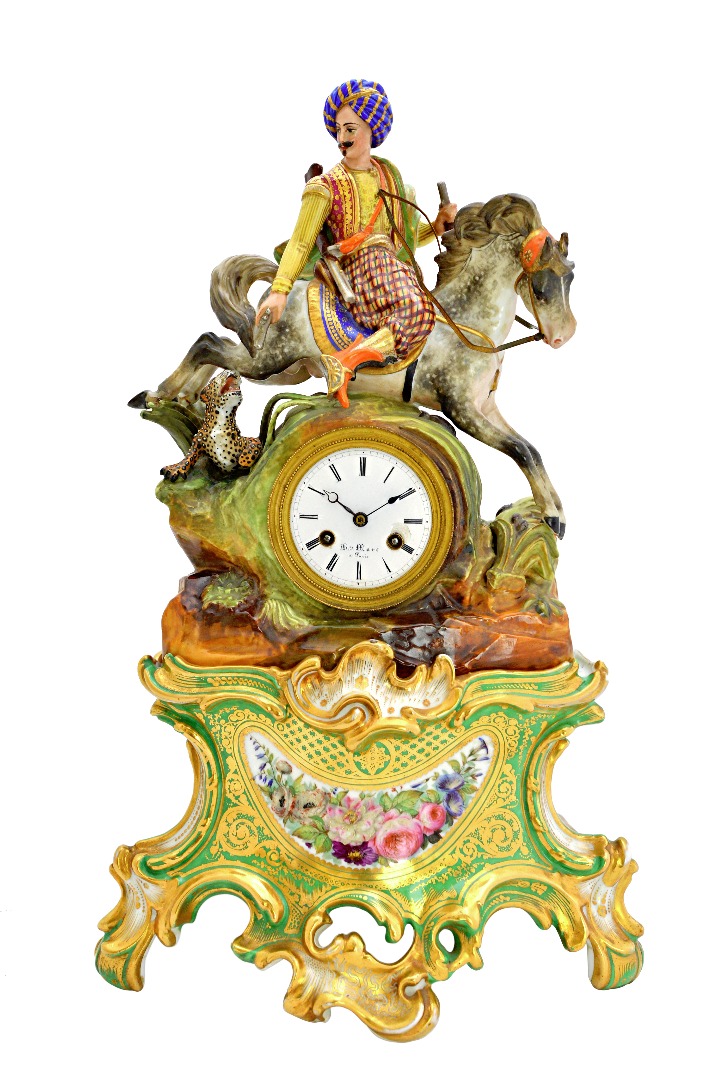 Appraisal: A porcelain mantel clock on stand 'Hun figure' mid- th