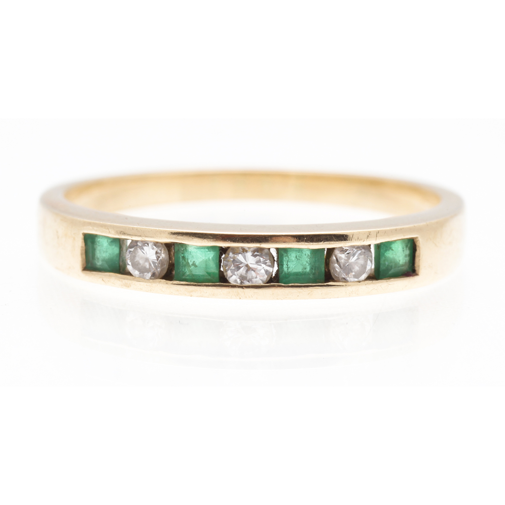 Appraisal: An emerald and diamond set band channel set with alternating