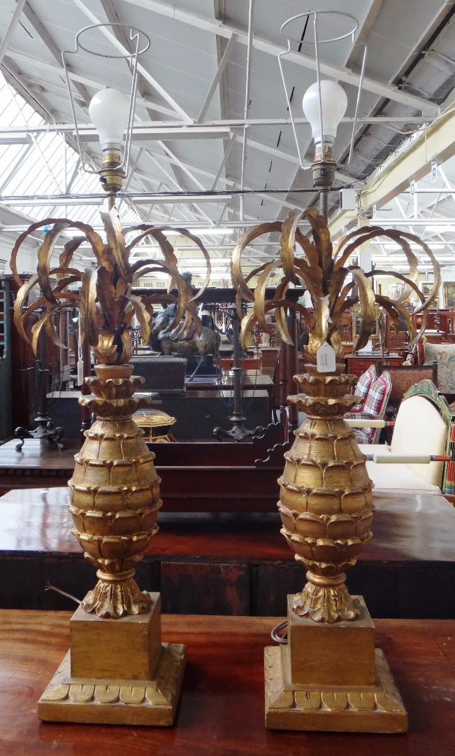 Appraisal: A pair of giltwood and metal worked table lamps with