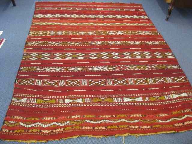 Appraisal: Tribal Rug linear geometric design on red '' x ''