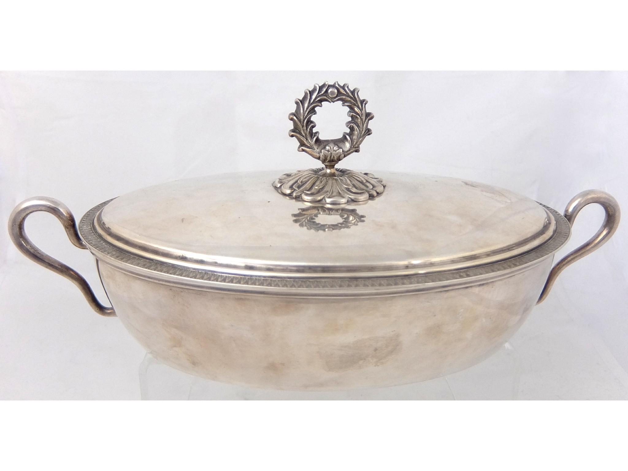 Appraisal: A white metal tureen and coverof oval shape with twin