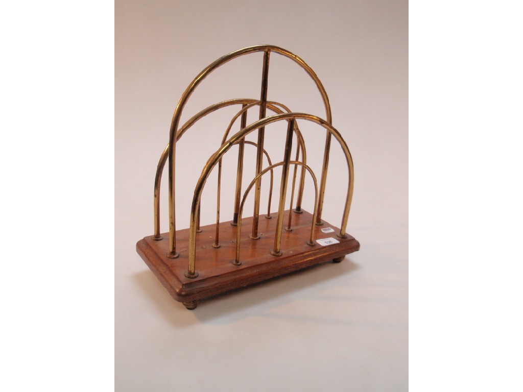 Appraisal: An Edwardian oak and brass magazine rack