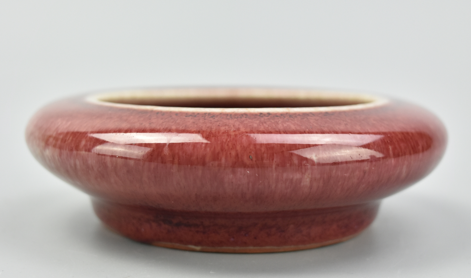 Appraisal: CHINESE FLAMBE RED GLAZED WASHER TH C This Qing dynasty