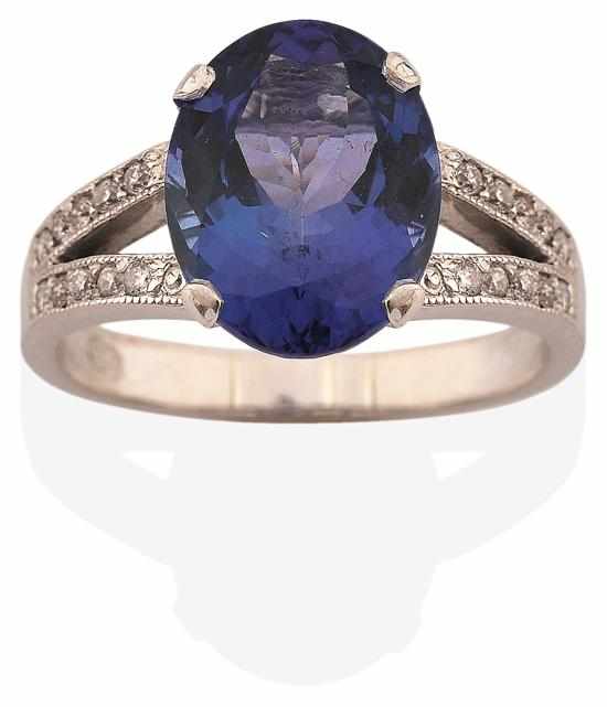 Appraisal: A TANZANITE AND DIAMOND RING Centrally set with an oval