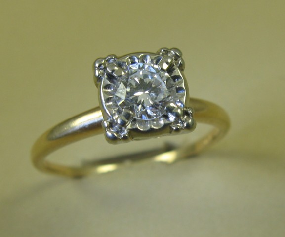 Appraisal: DIAMOND AND FOURTEEN KARAT GOLD RING centering a round brilliant-cut