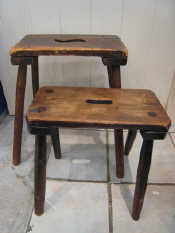 Appraisal: Two rustic four legged stools both with hand holds one