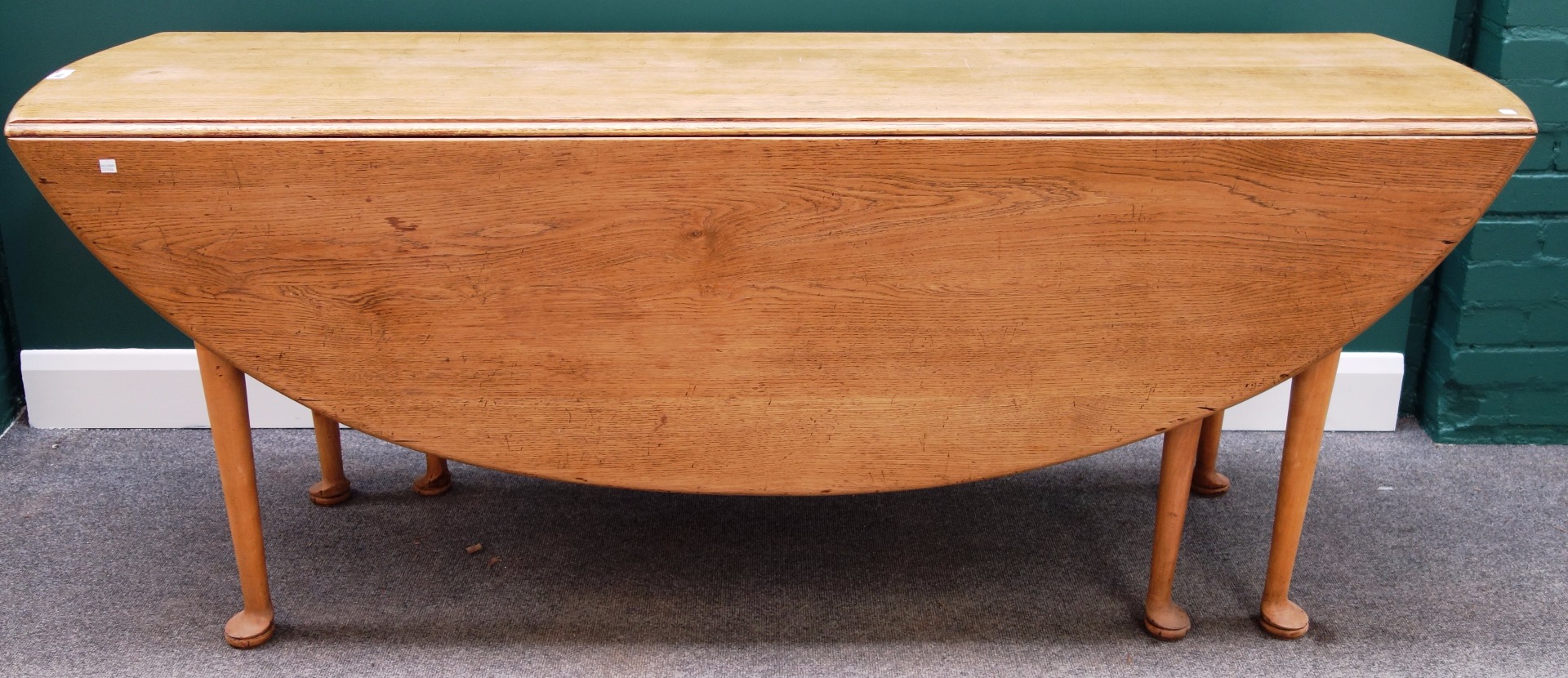 Appraisal: A large th century style oak oval drop flap dining