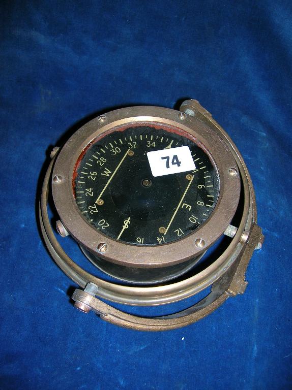 Appraisal: A magnetic compass mounted on a set of gimbals for