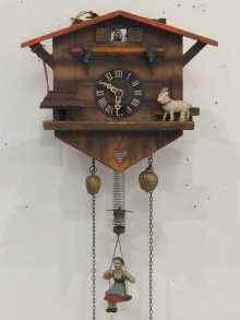 Appraisal: A Swiss cuckoo clock with girl on swing pendulum