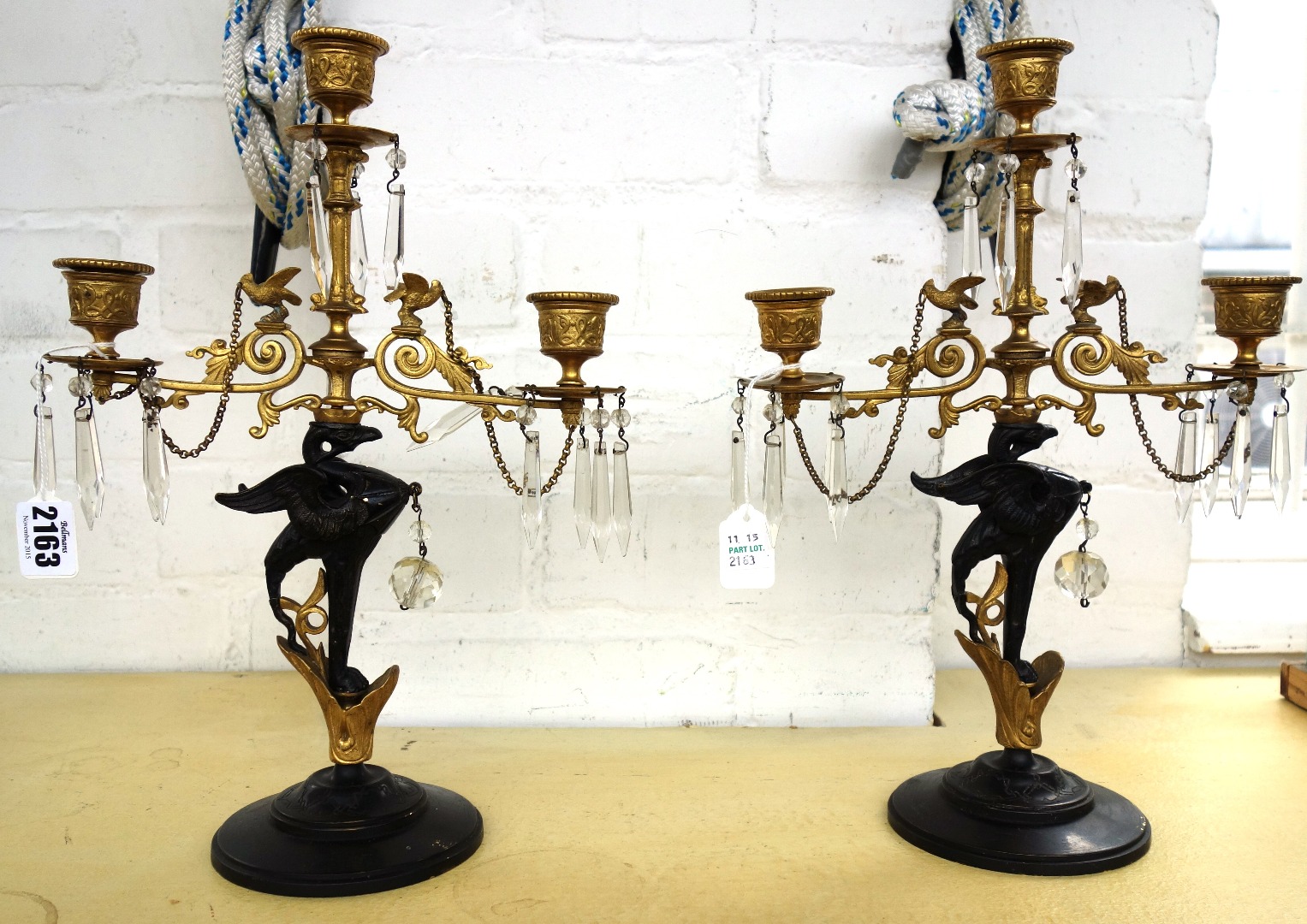 Appraisal: A pair of gilt and ebonised brass three branch candelabra