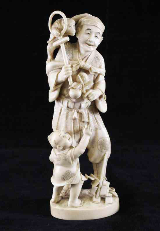 Appraisal: A Japanese ivory figure of a monkey trainer and boy