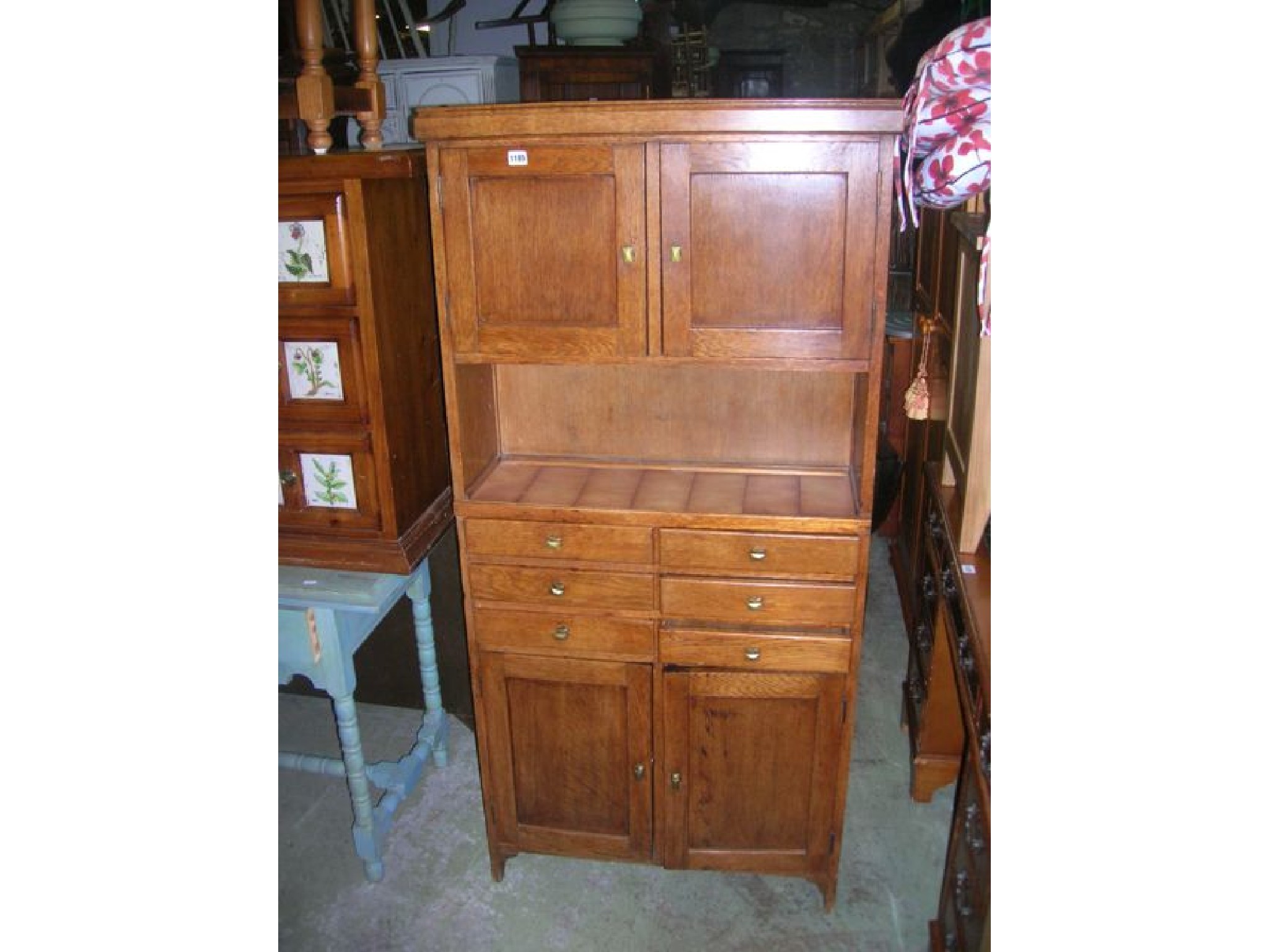 Appraisal: A small vintage oak freestanding side cabinet partially enclosed by