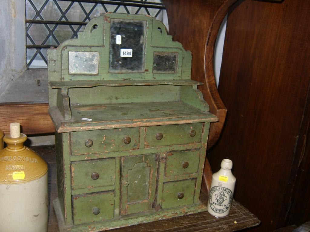 Appraisal: A miniature rustic painted pine dresser fitted with an arrangement