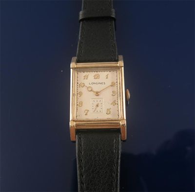 Appraisal: A rectangular gold plated wristwatch by Longines with gold Arabic