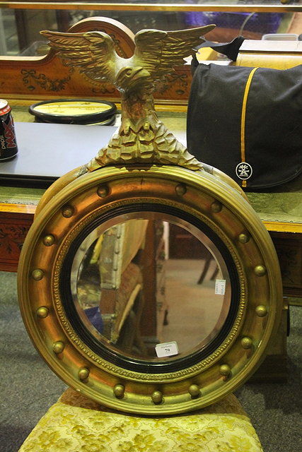 Appraisal: A TH CENTURY GILT CIRCULAR WALL MIRROR with eagle mount