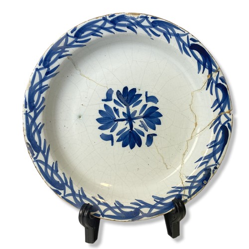 Appraisal: An th-century Delft ware plate Central floral motif with similar