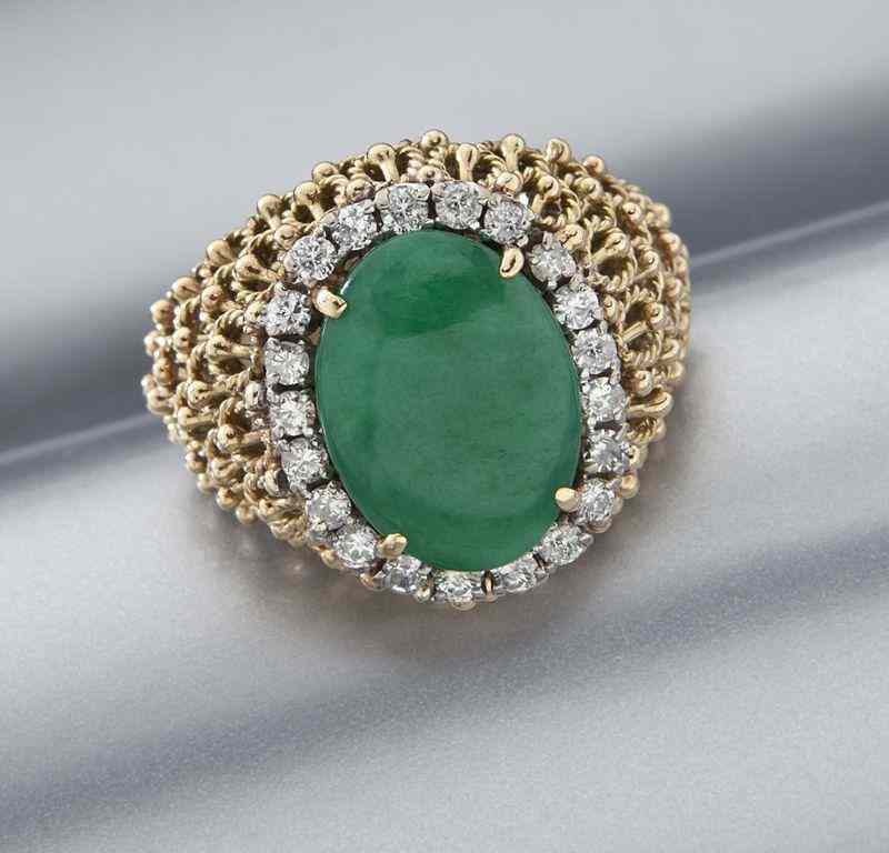 Appraisal: K gold jadeite and diamond ringfeaturing a central oval cabochon