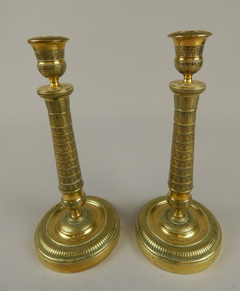 Appraisal: A pair of thC Indian brass candlesticks each with vase