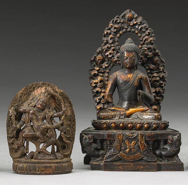 Appraisal: Two Nepalese carved wood Buddhist deities The first a figure