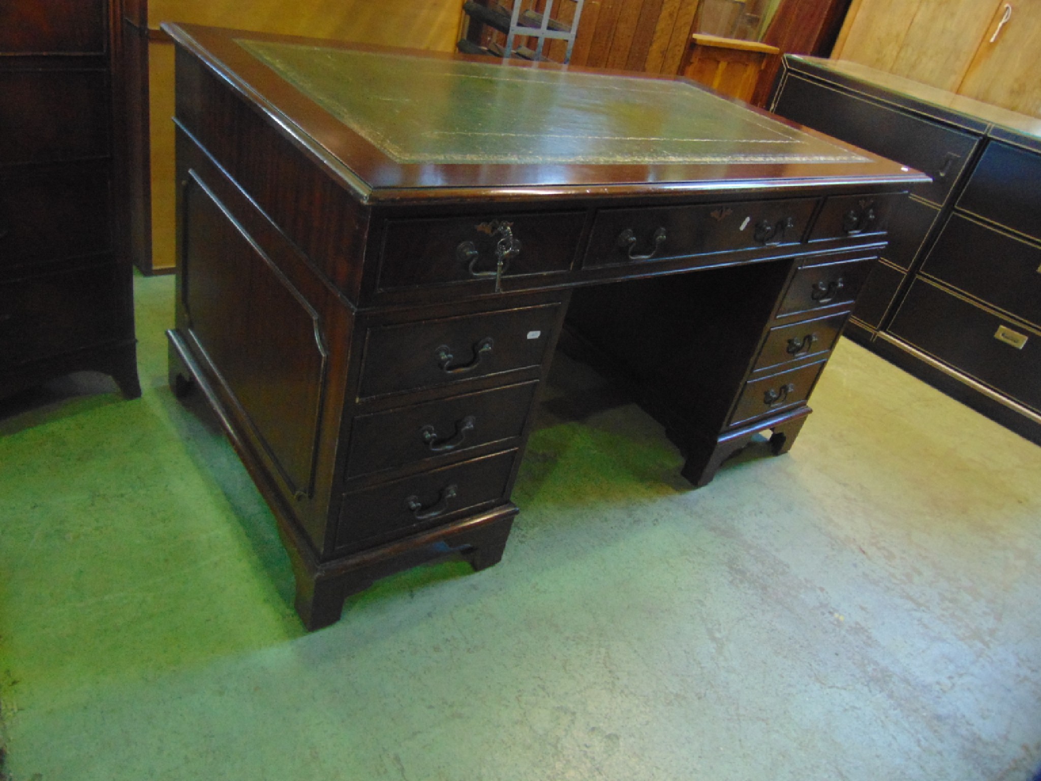 Appraisal: A reproduction mahogany kneehole twin pedestal writing desk in the